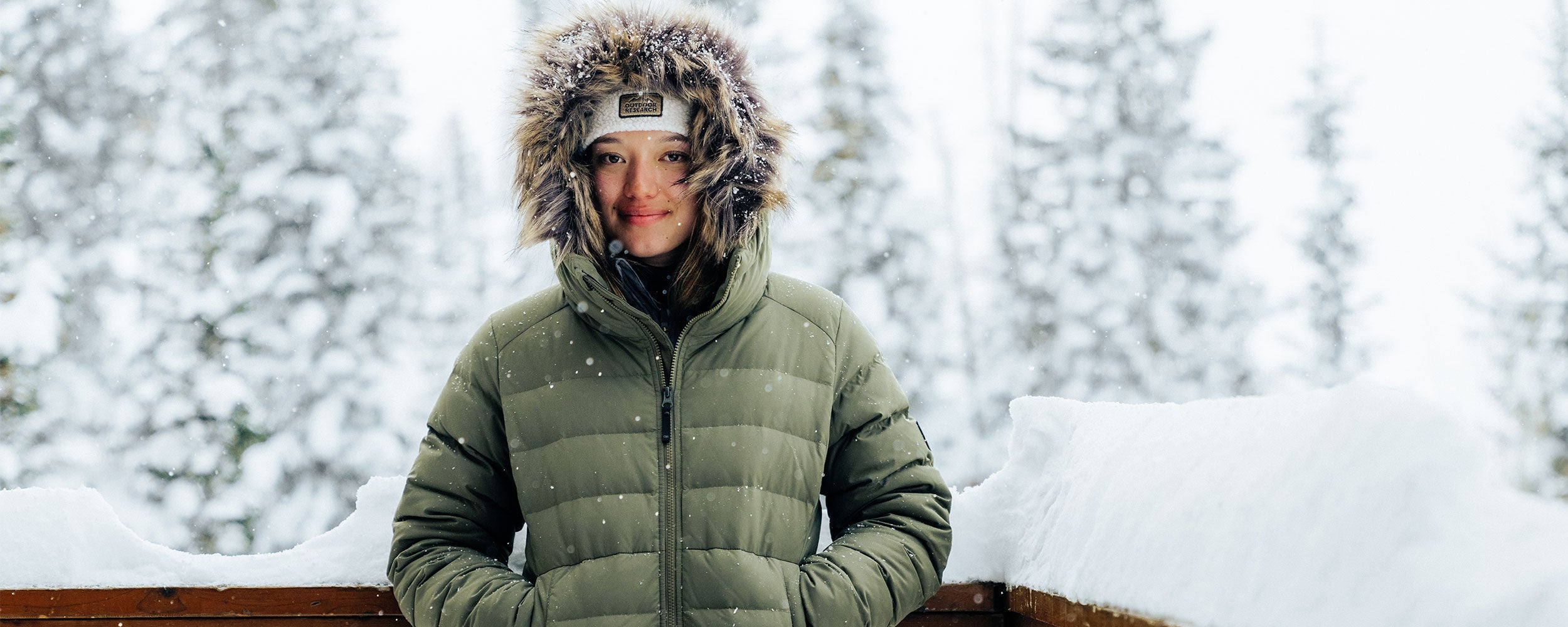 Outdoor Research Ski athlete Zoe Atkin stays warm in the Outdoor Research Women's Coze Lux Down Parka in Ranger Green.