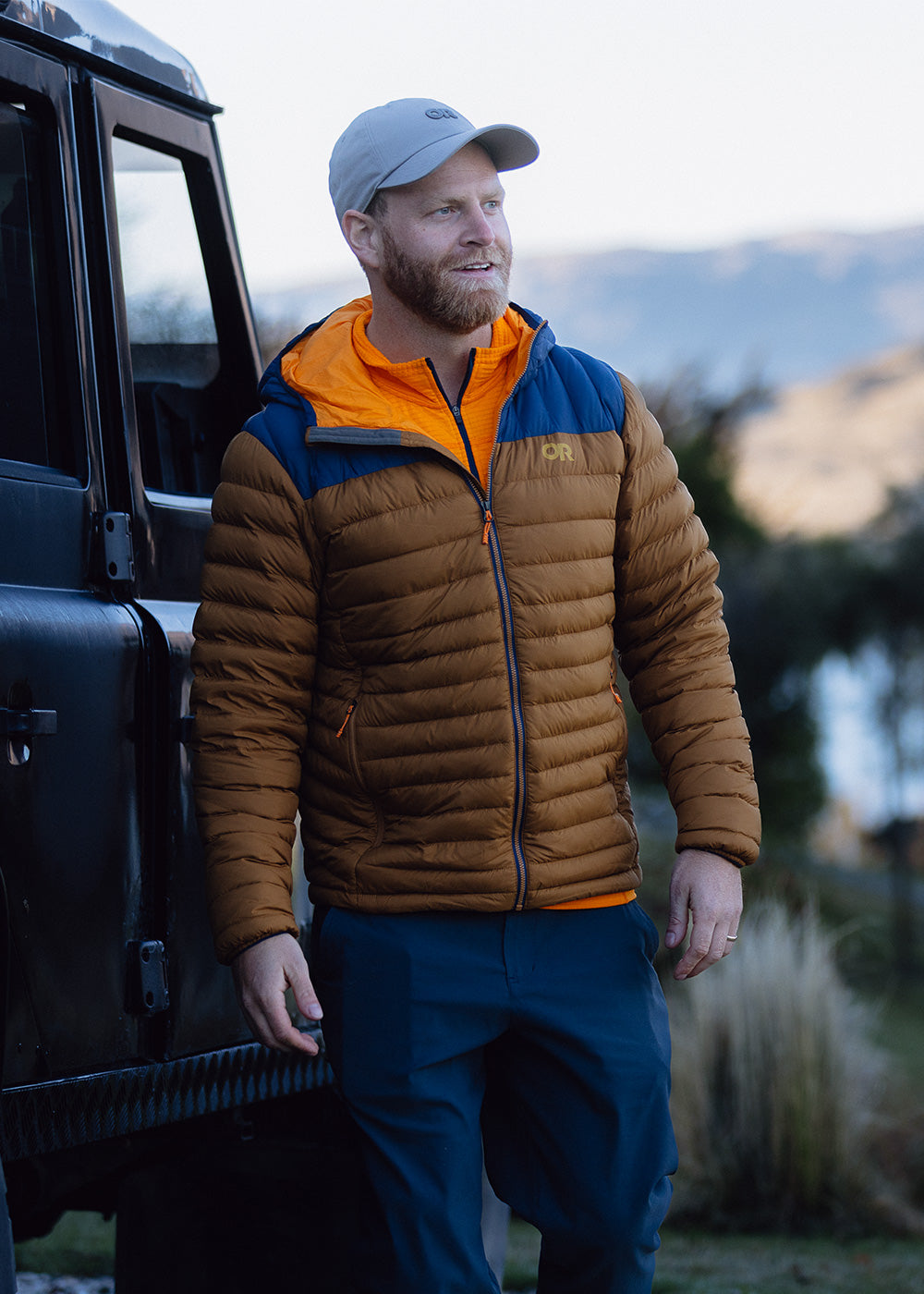 Two men walk outside wearing the Transcendent Down Hoodie.