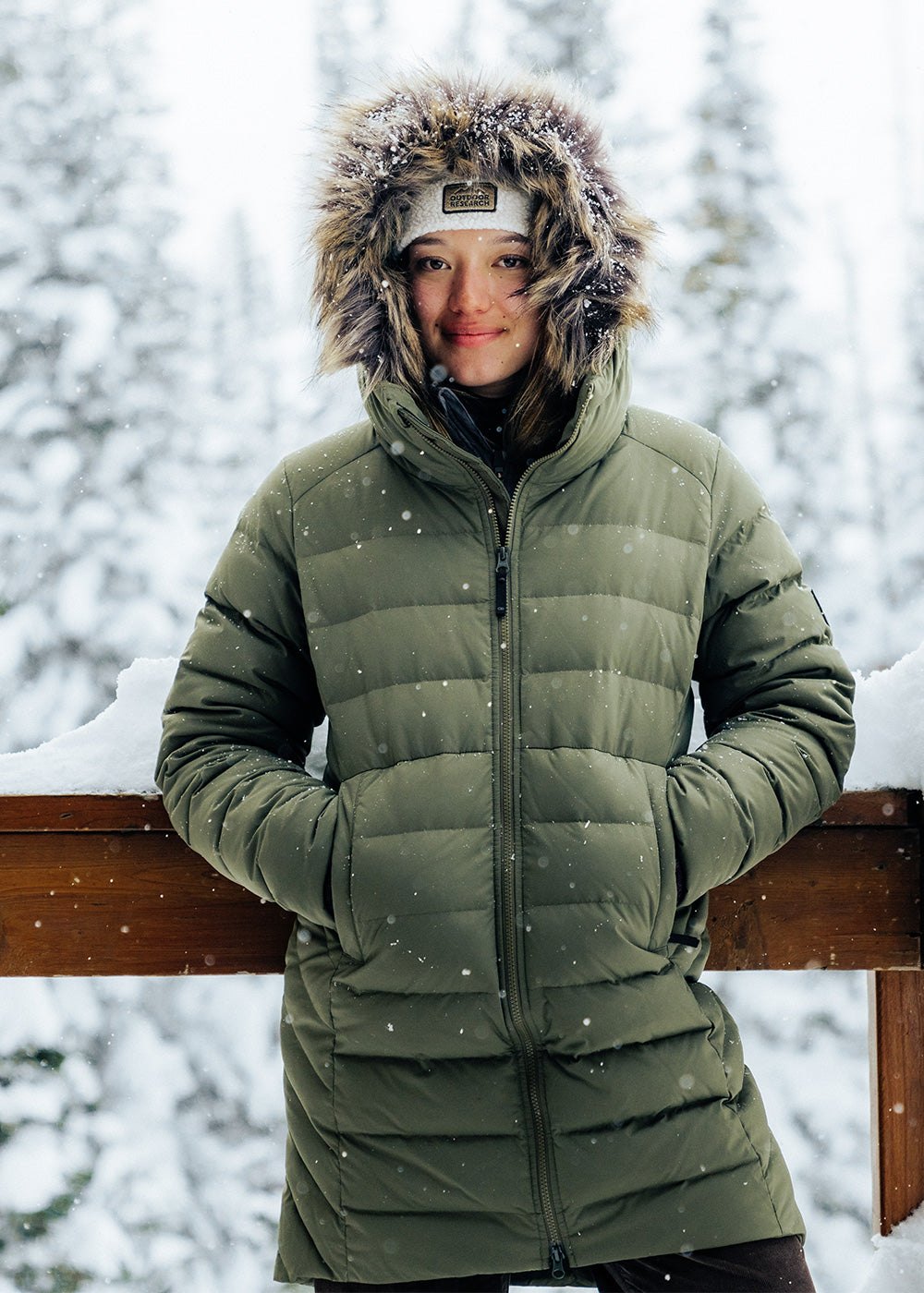 Outdoor Research Ski athlete Zoe Atkin stays warm in the Outdoor Research Women's Coze Lux Down Parka in Ranger Green.