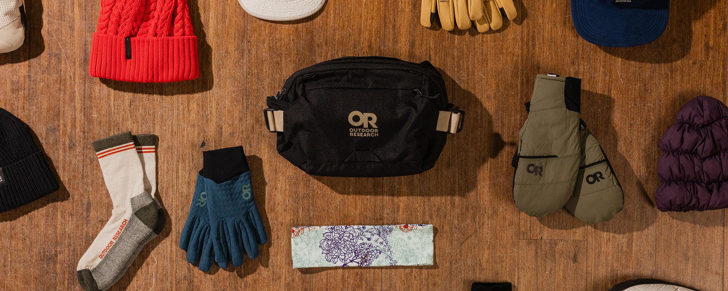 Overhead view of Outdoor Research gloves, beanies, and accessories.