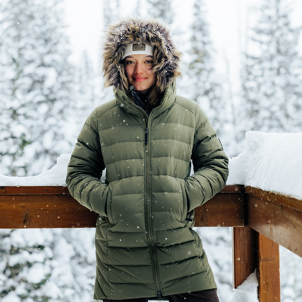 Outdoor Research Ski athlete Zoe Atkin stays warm in the Outdoor Research Women's Coze Lux Down Parka in Ranger Green.