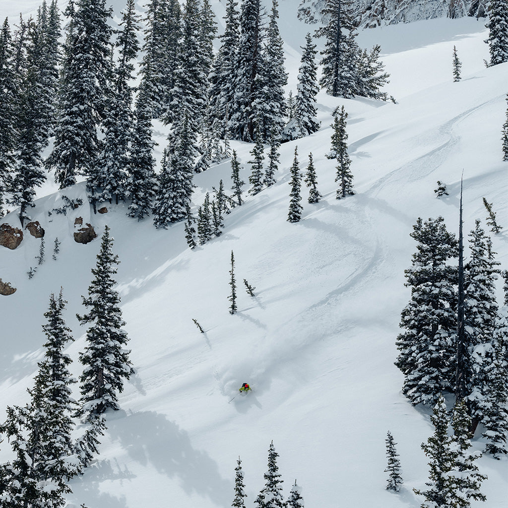 Birdseye view of a skier taking turns through fresh powder.